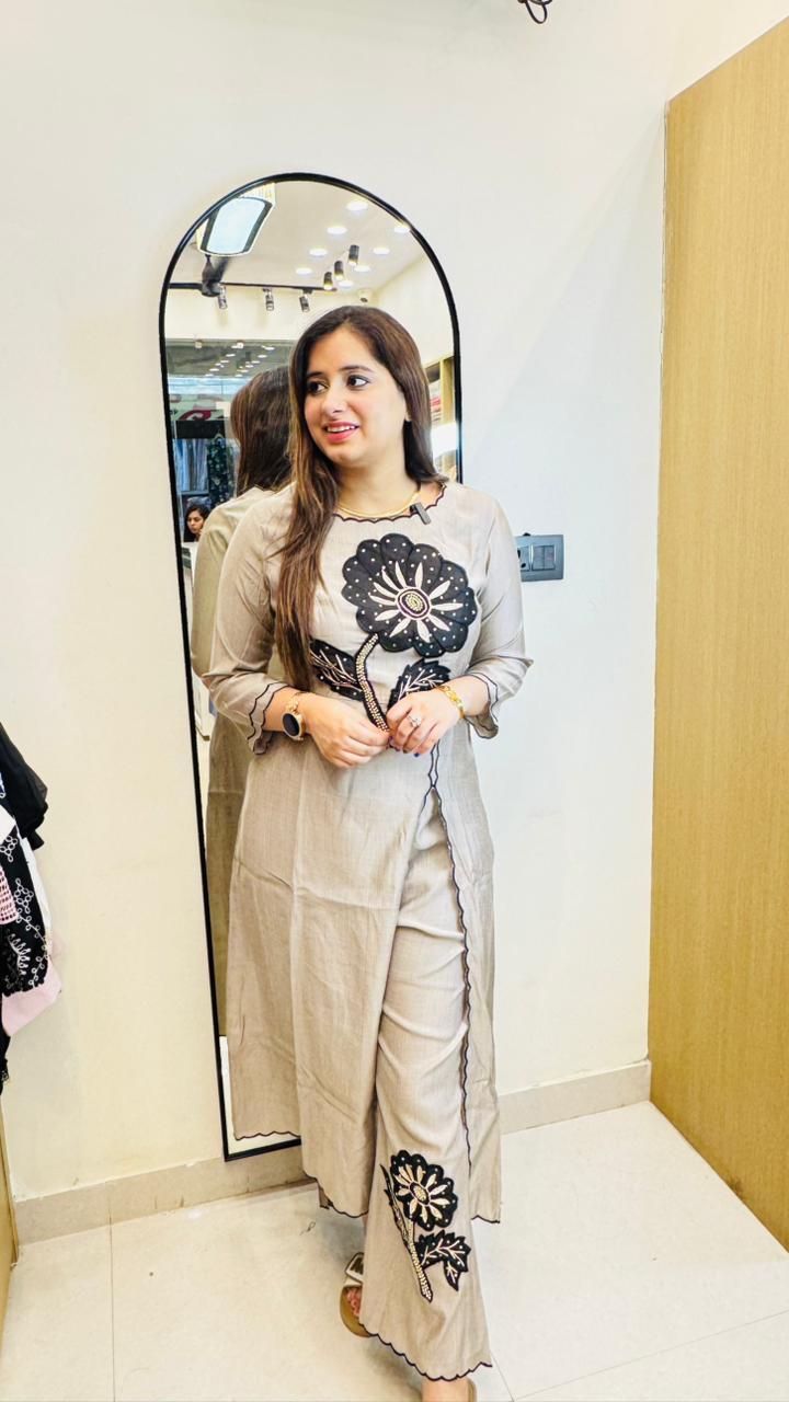 FAMINA | Beige Asymmetric Floral Kurta Set with Black Appliqué – Modern Designer Pant Suit