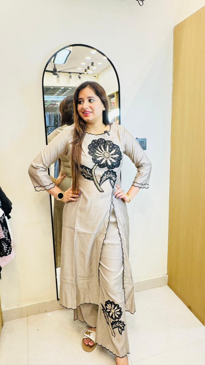 FAMINA | Beige Asymmetric Floral Kurta Set with Black Appliqué – Modern Designer Pant Suit